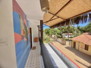 a hallway of a building with a mural on the wall at Pousada Numei de Jeri in Jericoacoara