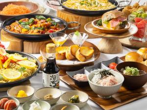 a table with many different plates of food and drinks at Kanku Izumiotsu Washington Hotel in Izumiotsu