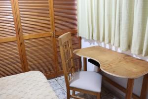 a wooden table and chair next to a table and a chair at Hotel 7 Rooms in Guadalajara