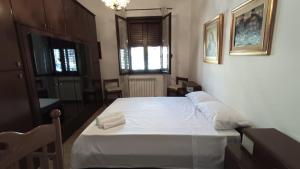 a bedroom with a bed with two towels on it at La Dimora di Gianna in Palermo