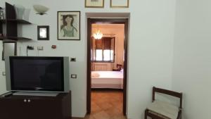 a living room with a television and a bedroom at La Dimora di Gianna in Palermo