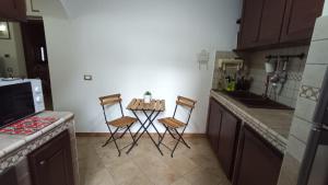 a kitchen with a small table and two chairs at La Dimora di Gianna in Palermo +10 photos