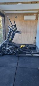 a pile of ski equipment sitting in a garage at Rangitoto Retreat Raglan in Te Akau