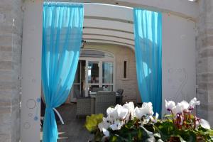 a pair of blue curtains in a living room at Casale Porto Contessa in Polignano a Mare