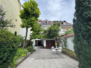 a courtyard with a table and chairs and a building at The sanctuary ljubljana in Ljubljana