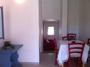 ヴィッラシミーウスにあるSul Mare Sardegna Villa Acteaのダイニングルーム(テーブル、椅子付)、ソファ付きの部屋