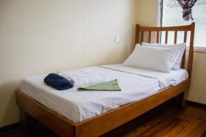 a bed with two pillows and a napkin on it at Tanuli Heights in Honiara +17 photos