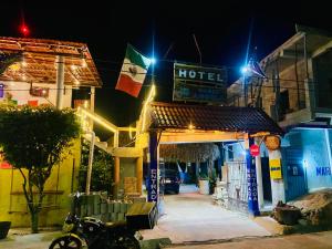 a motorcycle parked in front of a hotel at night at HotelMariaAngela in Dzuiché