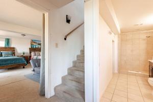 a staircase in a room with a bedroom at Riverfalls Retreat in Oakhurst