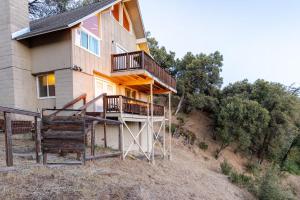 a house with a staircase in front of it at Riverfalls Retreat in Oakhurst