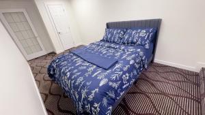 a small bedroom with a bed with a blue blanket at Entire condo in White Rock, Canada in White Rock