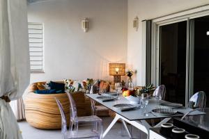 a living room with a table and a couch at Villa Madame in Saint Martin