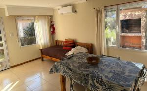 a living room with a table and a couch at Cabañas Hueney Ruca in Sierra de la Ventana