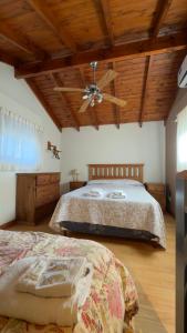 a bedroom with a bed and a ceiling fan at Cabañas Hueney Ruca in Sierra de la Ventana +73 photos