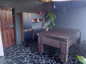 a kitchen with a wooden table in a room at Recanto Eucaliptos in Araçoiaba da Serra