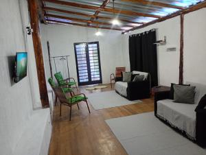 a living room with a couch and a tv at Recanto Eucaliptos in Araçoiaba da Serra