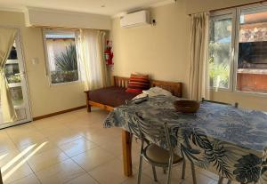 a living room with a table and a couch at Cabañas Hueney Ruca in Sierra de la Ventana