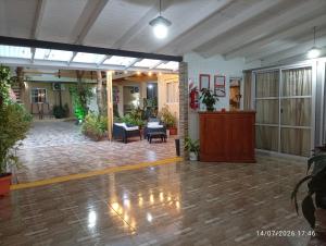 a large room with a lobby with plants at Alojamiento mei-mei in Puerto Iguazú