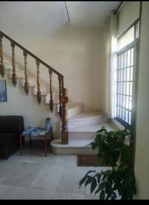 a staircase in a living room with a stair case at Hotel Benalua in Isla de Arosa