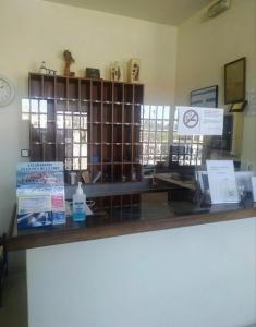 a counter in a store with signs on it at Hotel Benalua in Isla de Arosa