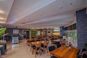 a restaurant with wooden tables and chairs at saffari otel in Ankara