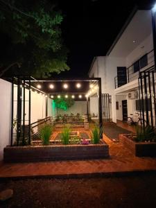 a patio with a table and chairs and lights at night at Complejo GARUPÁ in Garupá