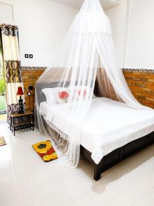 a bed with a mosquito net in a room at Gosela Bali in Munduk