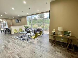 a living room with a couch and a table and chairs at Quality Inn in Elgin