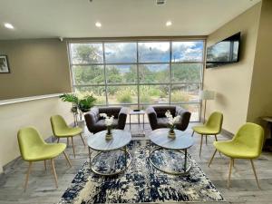 a living room with chairs and tables and a large window at Quality Inn in Elgin +4 photos