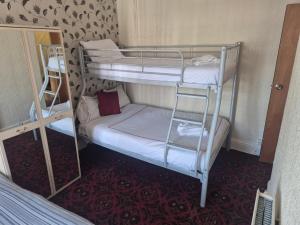 a couple of bunk beds in a room at White Moon Hotel in Blackpool
