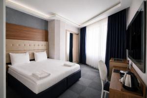 a hotel room with a bed and a television at saffari otel in Ankara