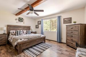 a bedroom with a bed and a ceiling fan at Peaceful Chalet in Oakhurst
