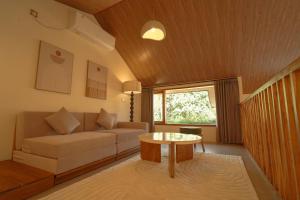 a living room with a couch and a table at enn Collection in Kuta Lombok