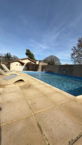 a swimming pool with a slide next to a house at Cabañas Hueney Ruca in Sierra de la Ventana