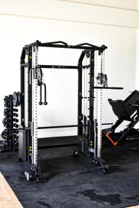 a gym with a squat rack and a barbell at Sossego na serra vista para vale e lazer completo in Bananeiras