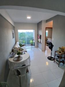 a living room with a couch and a table at Apartamento Completo com piscina e play infantil in Ananindeua