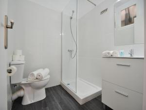 a white bathroom with a shower and a toilet at Hotel Boogaloo - Adults Only in El Arenal