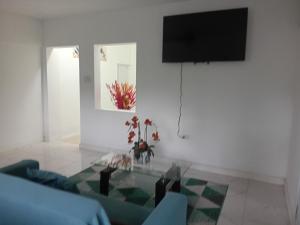 a living room with a tv and a glass table at Cozy Room with fast Internet & Netflix in Whitehall