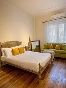 a bedroom with a large bed and a couch at El Otel Hotel in Cairo +39 photos