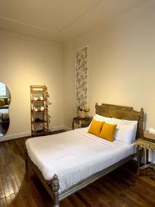 a bedroom with a bed with two yellow pillows at El Otel Hotel in Cairo