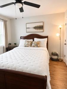 a bedroom with a large bed with a ceiling fan at Blue Haven Escape in Columbus