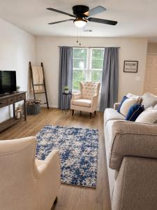 a living room with a couch and a ceiling fan at Blue Haven Escape in Columbus
