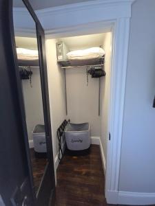 a room with three bunk beds and a mirror at The Fairview - North of Boston Furnished Home in Peabody +32 photos
