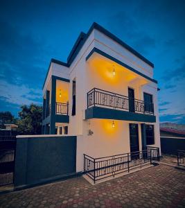 a white house with balconies on top of it at basalt&bamboo B&B in Ruhengeri
