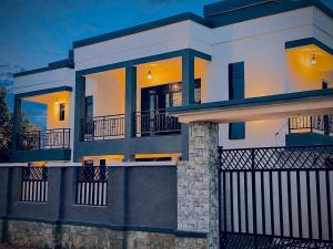 a large house with a fence in front of it at basalt&bamboo B&B in Ruhengeri
