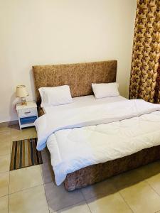 a bedroom with two beds and a night stand at basalt&bamboo B&B in Ruhengeri