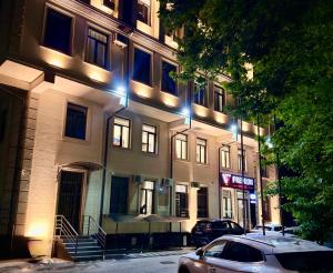 a building with lights on the side of it at Premium Yunusobod Hotel in Darkhon