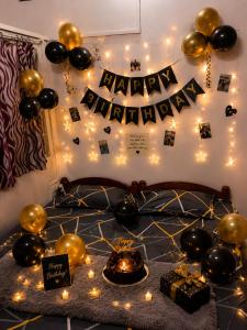 a bedroom with a happy birthday banner and balloons at Siddhi palace in Maihar