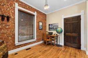 a brick room with a table and a brick wall at The Whittier Wonder in Denver