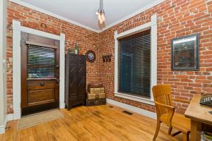 a brick room with a table and a chair and a brick wall at The Whittier Wonder in Denver